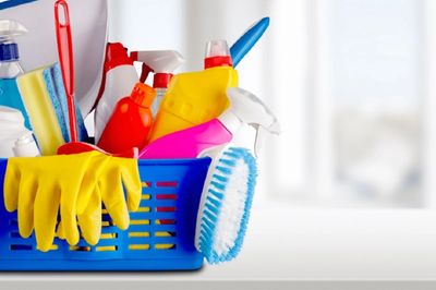 Colorful cleaning supplies in a caddy